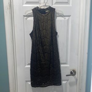 Black dress covered in gold lace